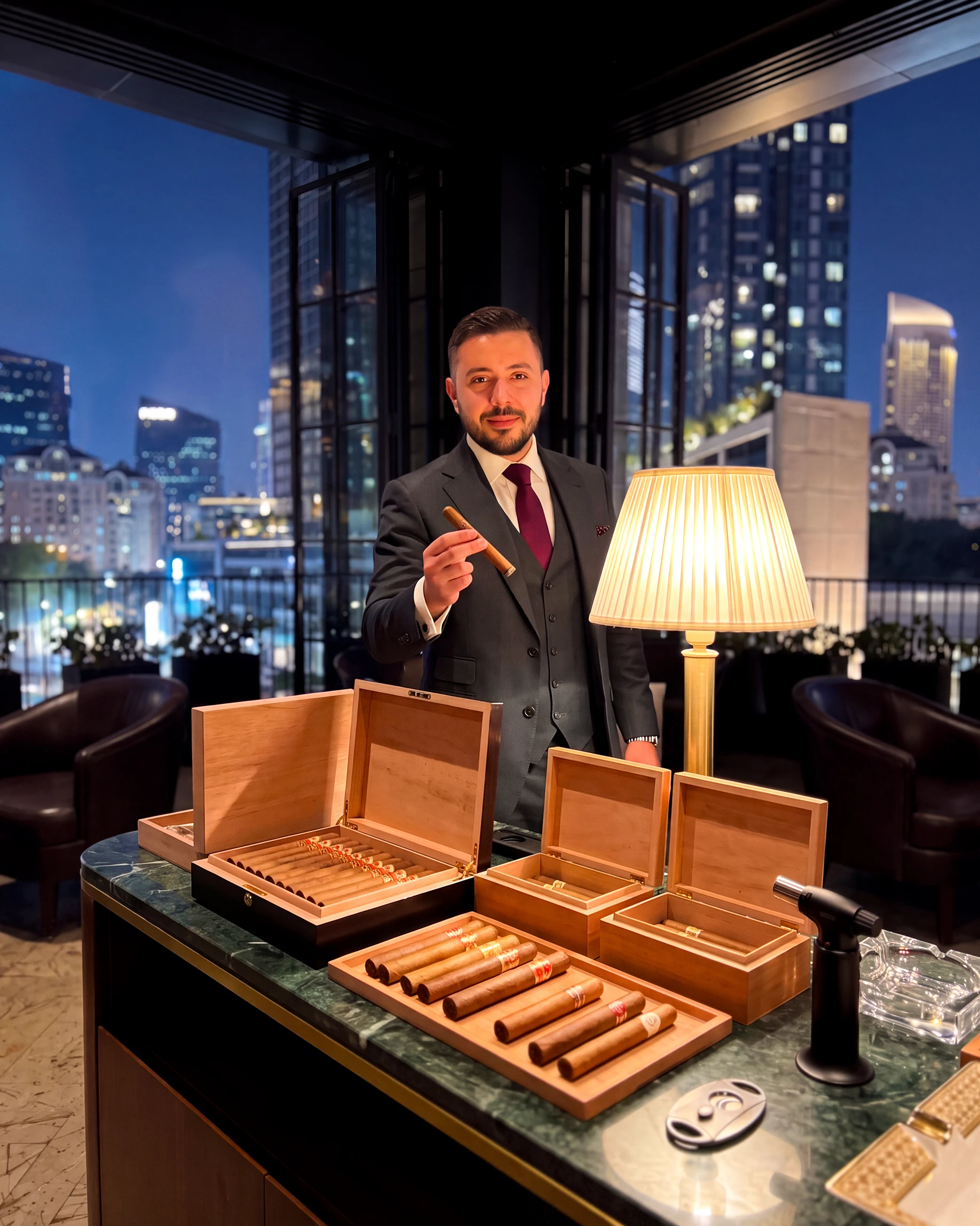 Guests mingling at an evening rooftop reception overlooking the city